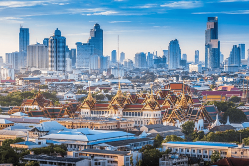 Which city should visitors consider: Hanoi or Bangkok?